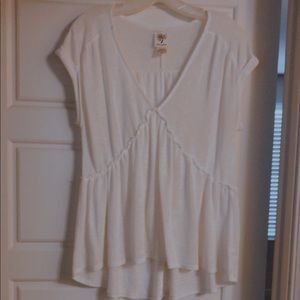 A white top with a v neck swoop